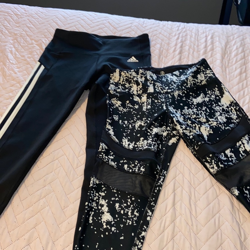 2 pair of black and white leggings. ONE is adidas while the other is vip perform